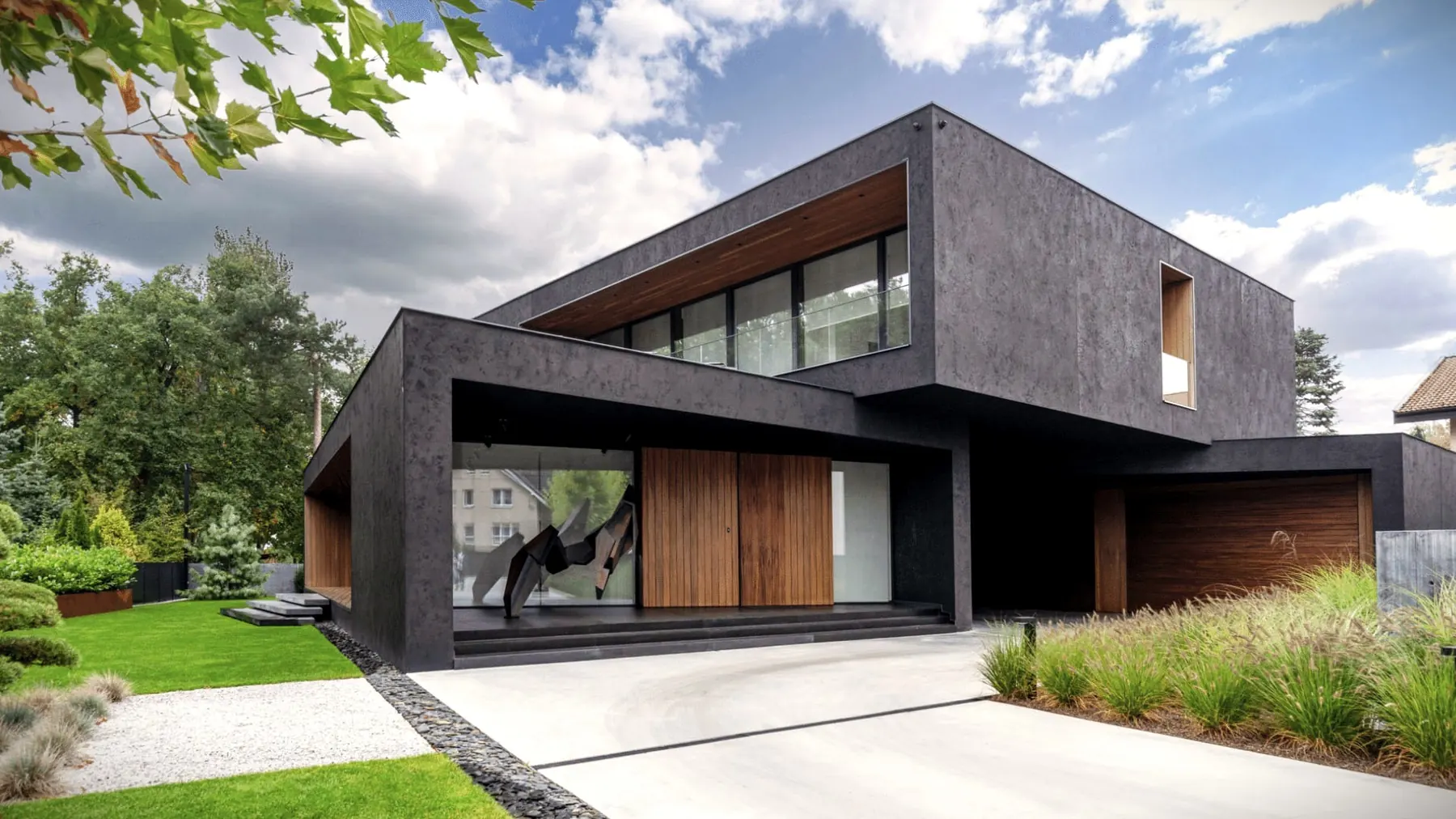 Modern dark house with African Sipo cladding and garage door